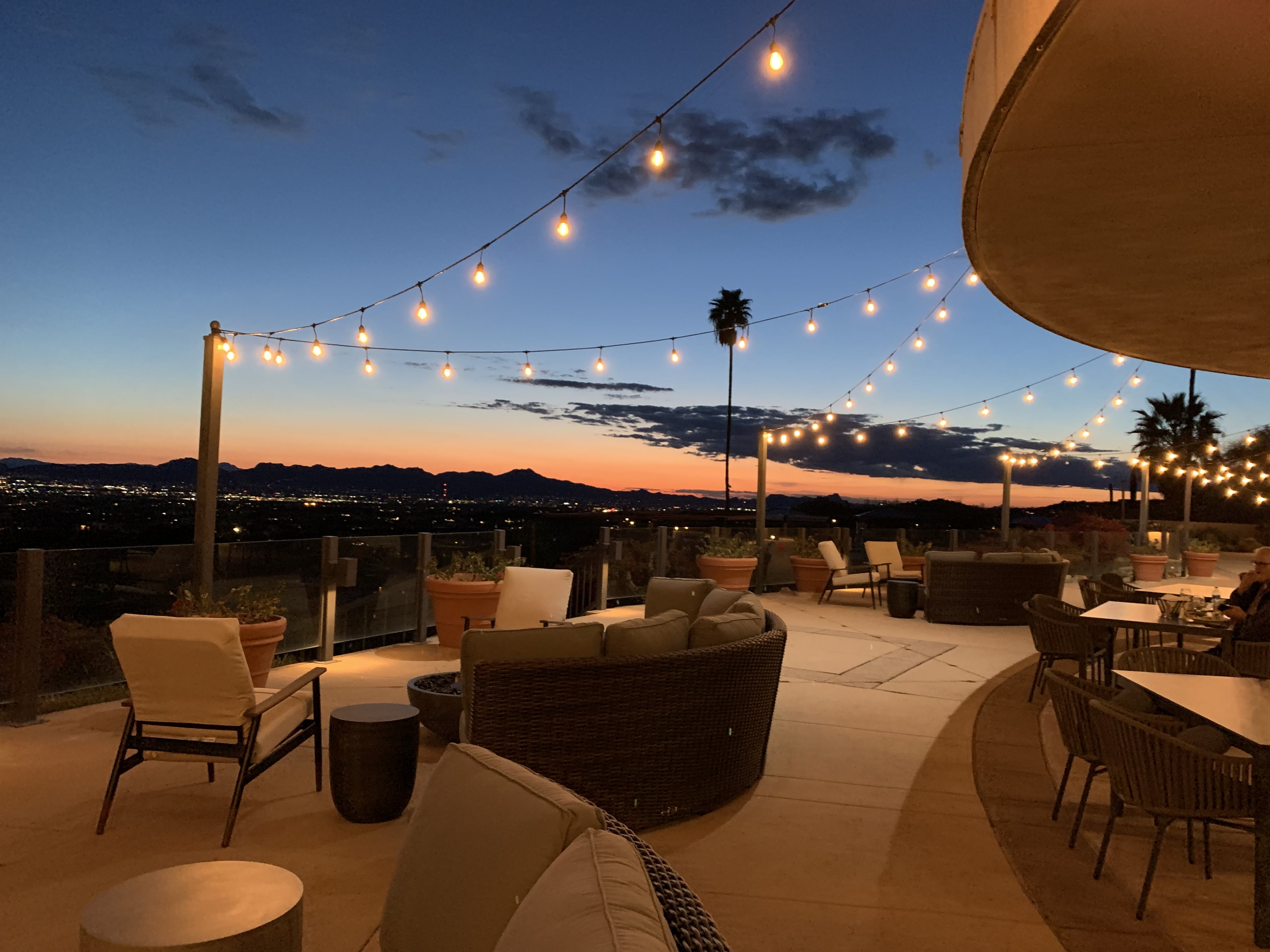 Indoor event venue with large windows overlooking mountain view