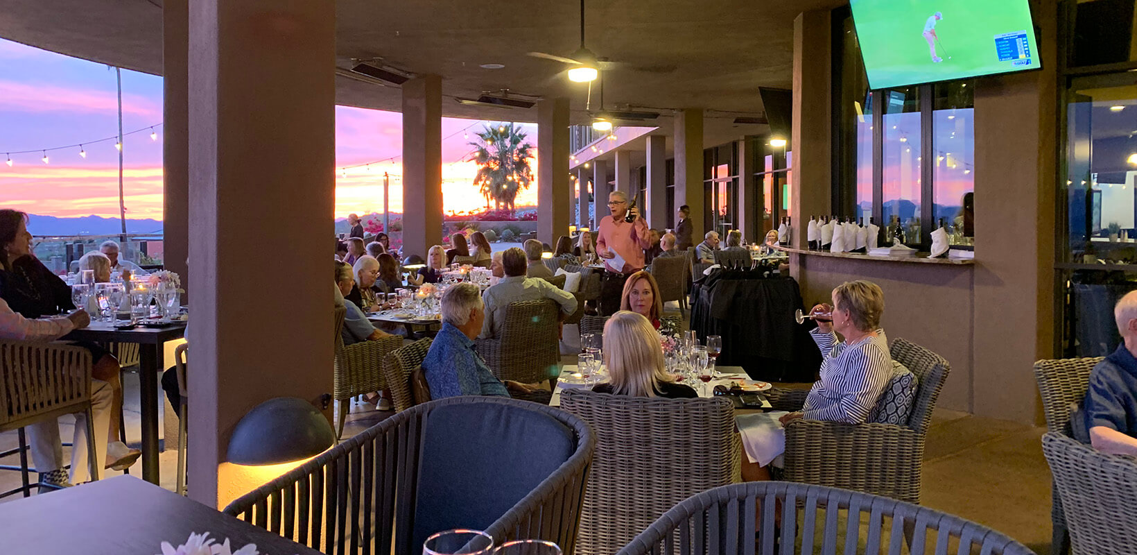 members enjoying the patio at sunset